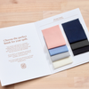 Fabric swatch book with color samples on a wooden surface