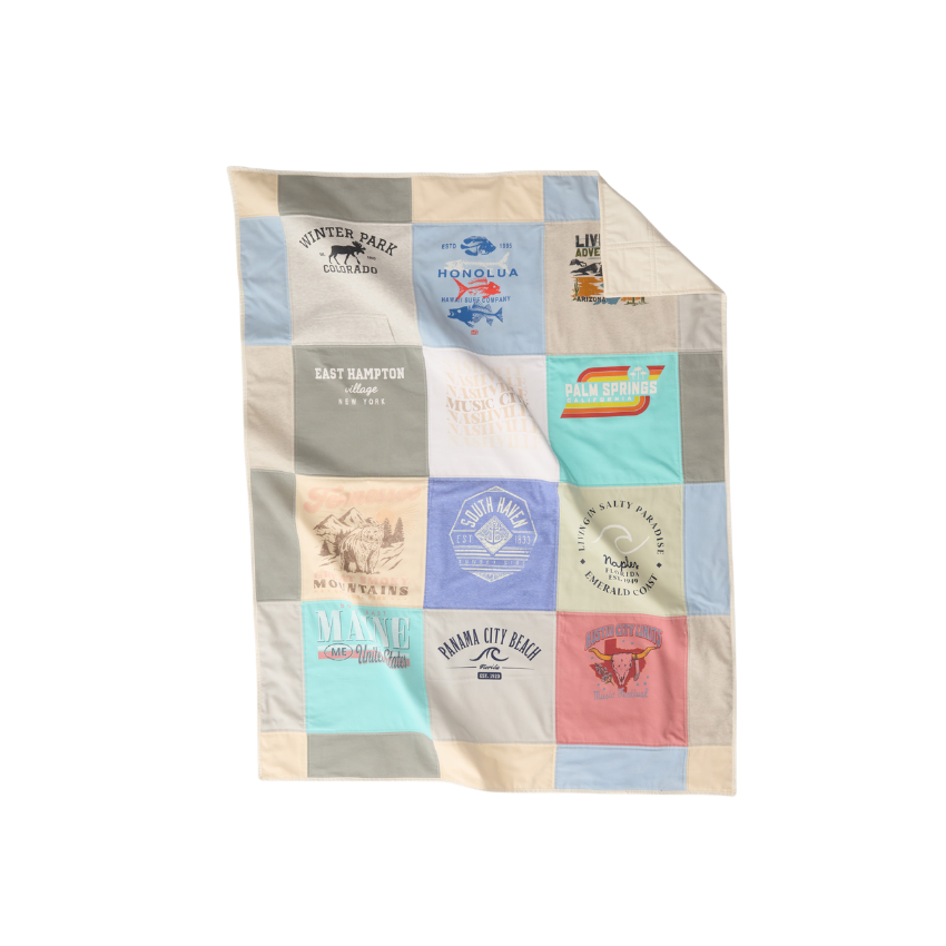 Nice Blanket Signature Memory Quilt made from travel-themed shirts in a 12 square grid in soft blue, ivory, gray, aqua, lavender, and coral, featuring destinations including Winter Park, Honolulu, East Hampton, Palm Springs, Maine, Panama City Beach, and other vacation memories.