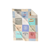 Nice Blanket Signature Memory Quilt made from travel-themed shirts in a 12 square grid in soft blue, ivory, gray, aqua, lavender, and coral, featuring destinations including Winter Park, Honolulu, East Hampton, Palm Springs, Maine, Panama City Beach, and other vacation memories.
