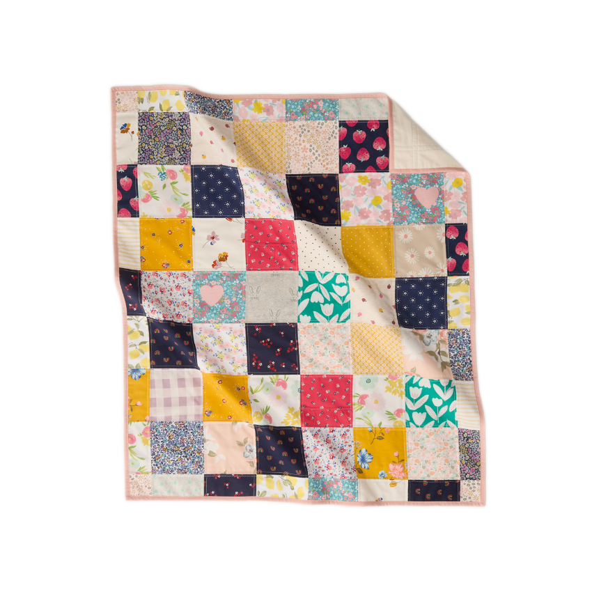 Nice Blanket Little Memories Quilt made from infant and toddler clothes, featuring a colorful patchwork of floral, fruit, heart, and patterned fabrics in pink, yellow, navy, green, and soft pastels.